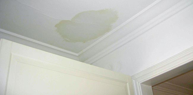 flat-roof-leak-water-damage-ceiling-bristol Water stain on ceiling caused by leaking flat roof in Bristol property