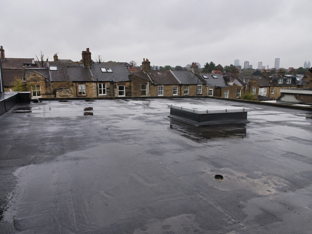 Standing water on flat roof in Bristol
